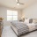 bedroom with bed window ceiling fan and dresser